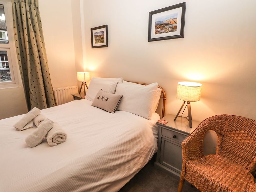 A bedroom with a bed and bedside table at Waterhead Cottage in Ambleside
