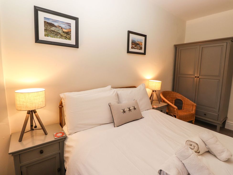 A bedroom with a bed and lamp at Waterhead Cottage in Ambleside