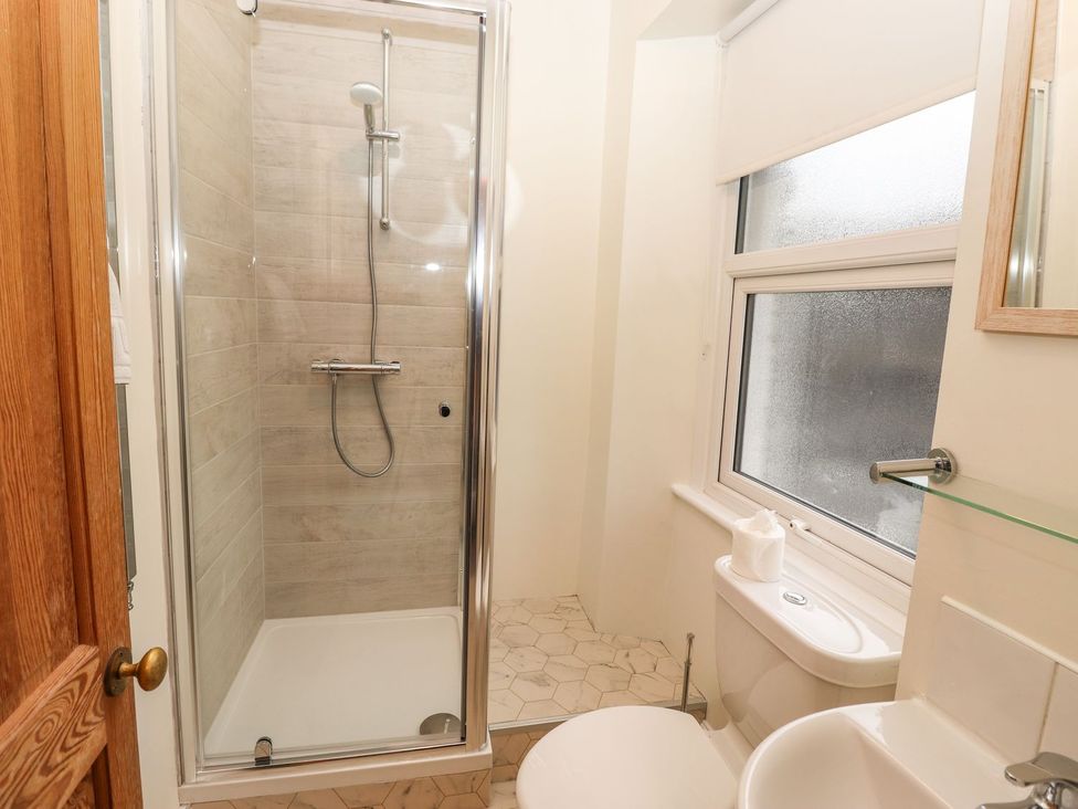 A bathroom with a shower, toilet, and sink at Waterhead Cottage in Ambleside