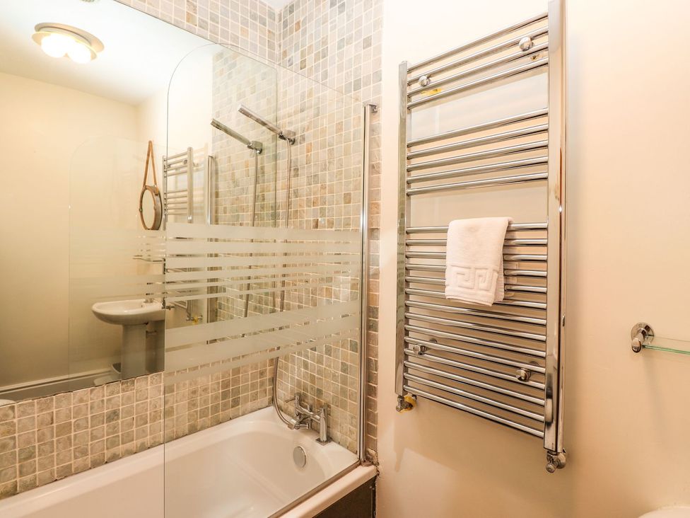 A bathroom with a bathtub and shower at Waterhead Cottage in Ambleside