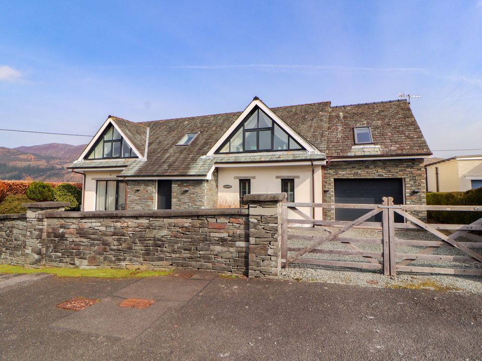 A house with mountains in the background at Lakes View in Keswick