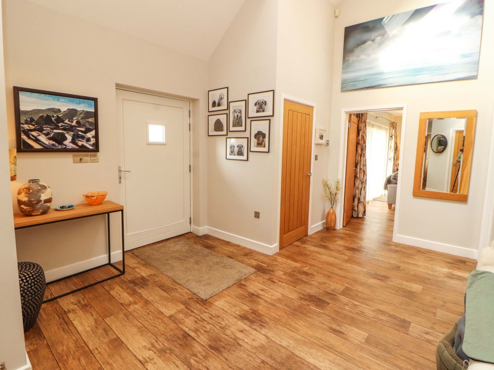 A hallway with a table and photographs at Lakes View in Keswick