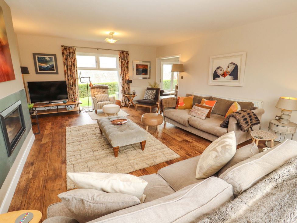A living room with a sofa and television at Lakes View in Keswick