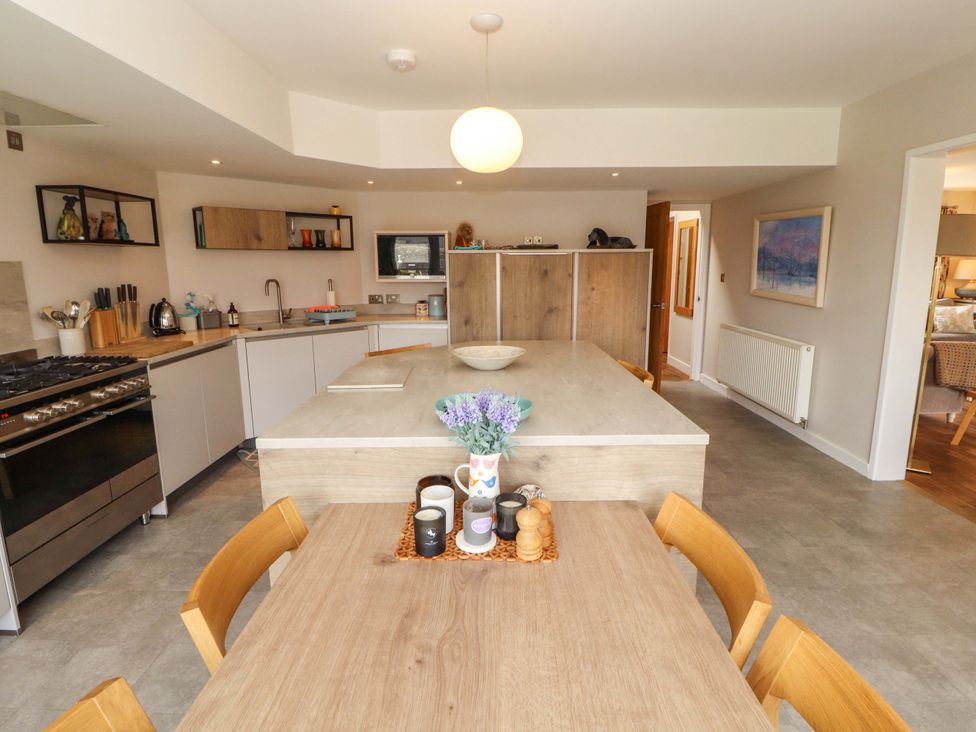 A kitchen with a table and chairs at Lakes View in Keswick