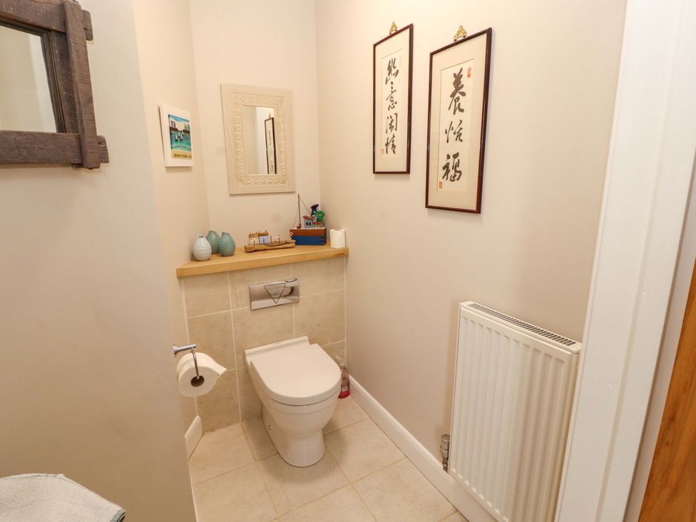 A small bathroom with a toilet and sink at Lakes View in Keswick