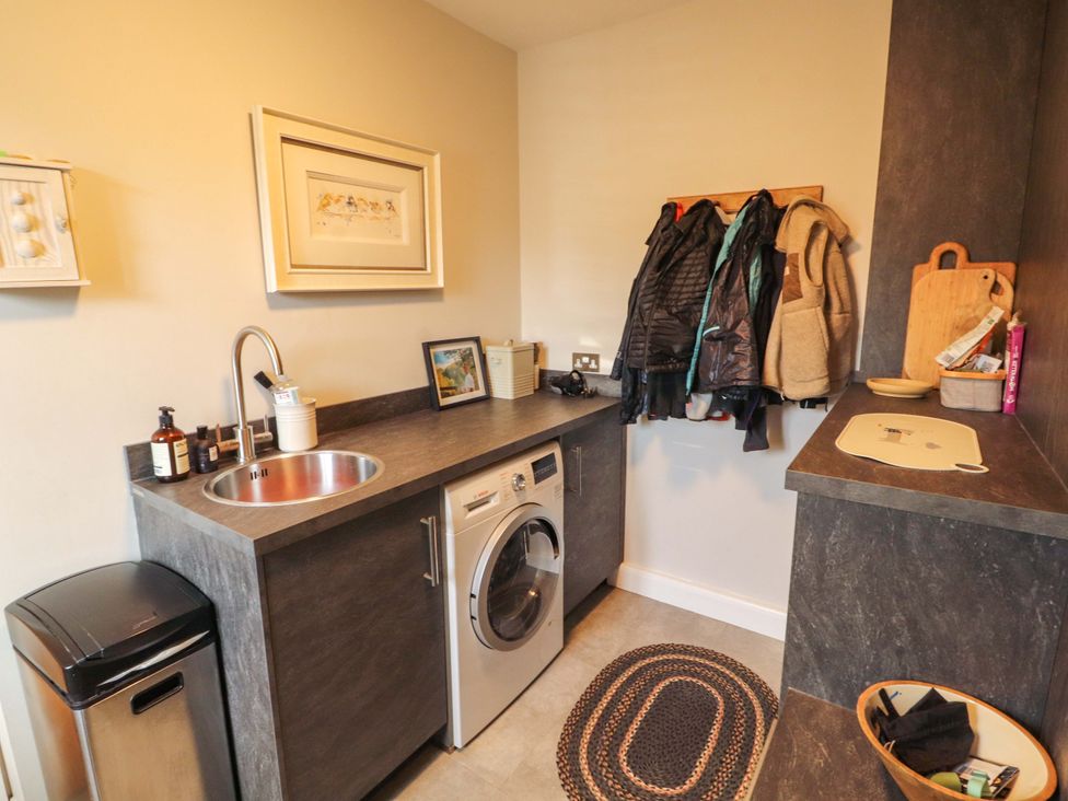 A laundry room with a washing machine and sink at Lakes View in Keswick