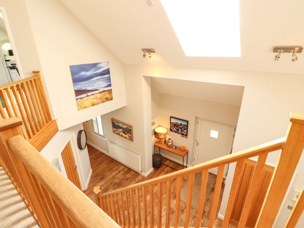 A hallway with a staircase and table at Lakes View in Keswick