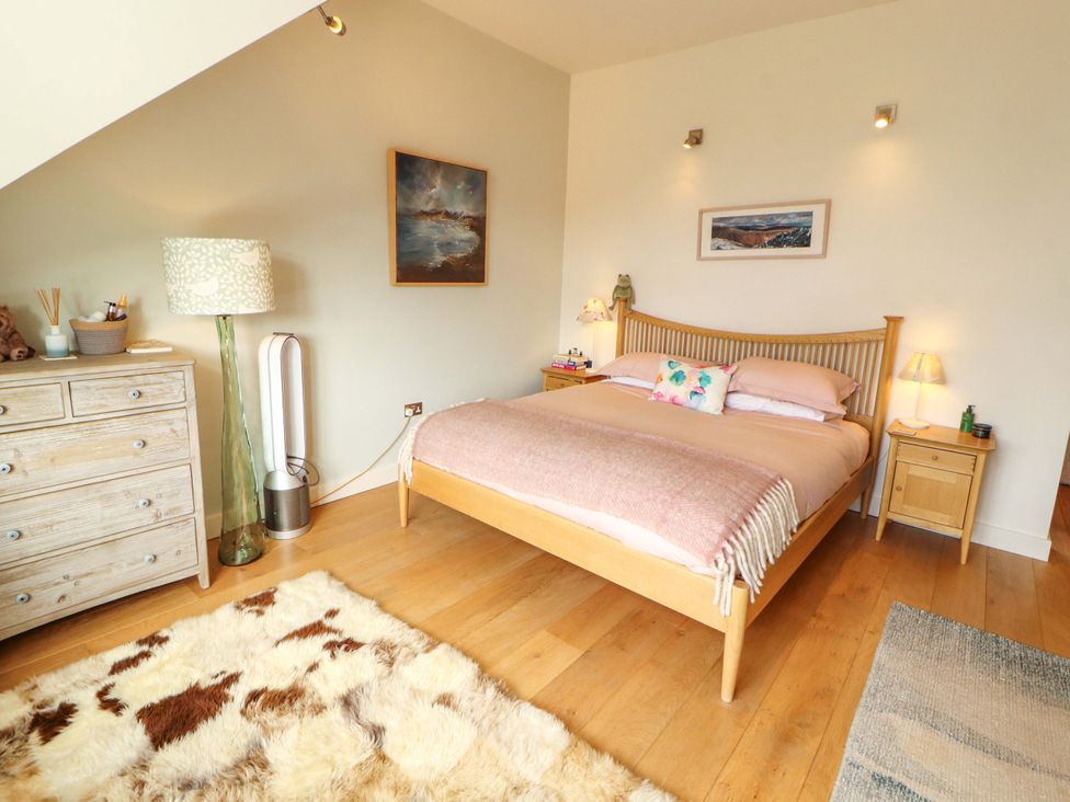 A bedroom with a bed and a dresser at Lakes View in Keswick