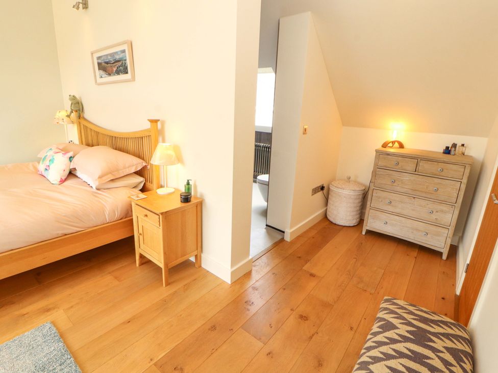 A bedroom with a bed and bedside table at Lakes View in Keswick