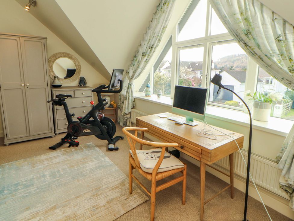 A home office with a desk and bike at Lakes View in Keswick
