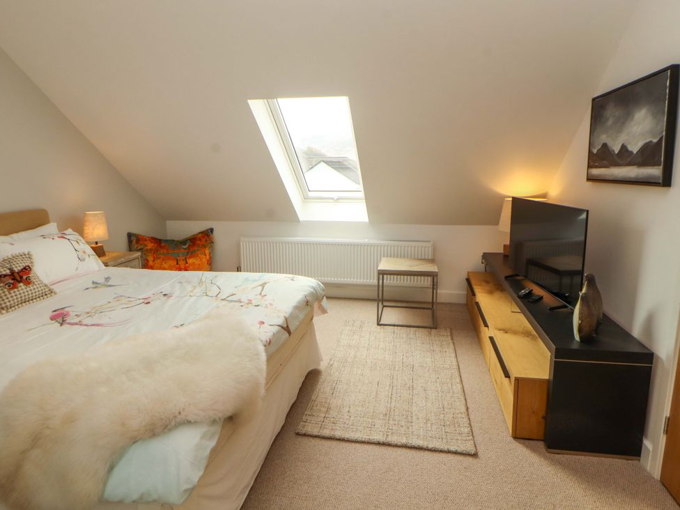 A bedroom with a bed and television at Lakes View in Keswick
