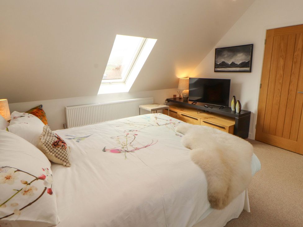 A bedroom with a bed and television at Lakes View in Keswick