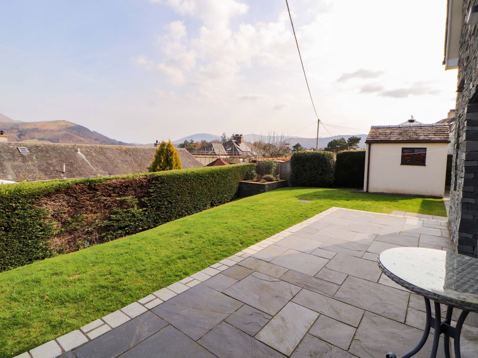 A garden with lawn and patio area at Lakes View in Keswick
