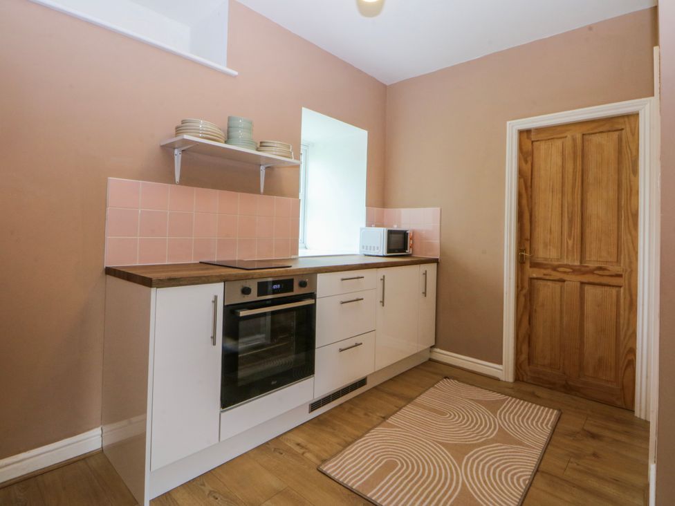 A kitchen with a countertop and appliances at Inglewood Bach in Conwy