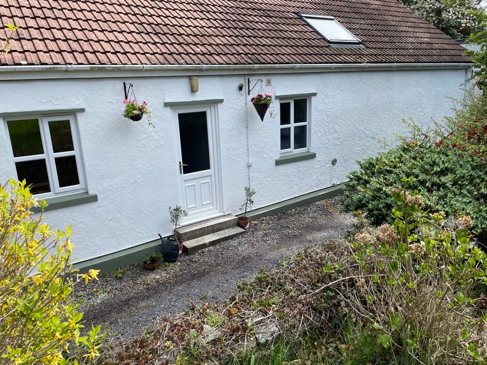 An exterior view of a house with a door and windows at Inglewood Bach, Conwy