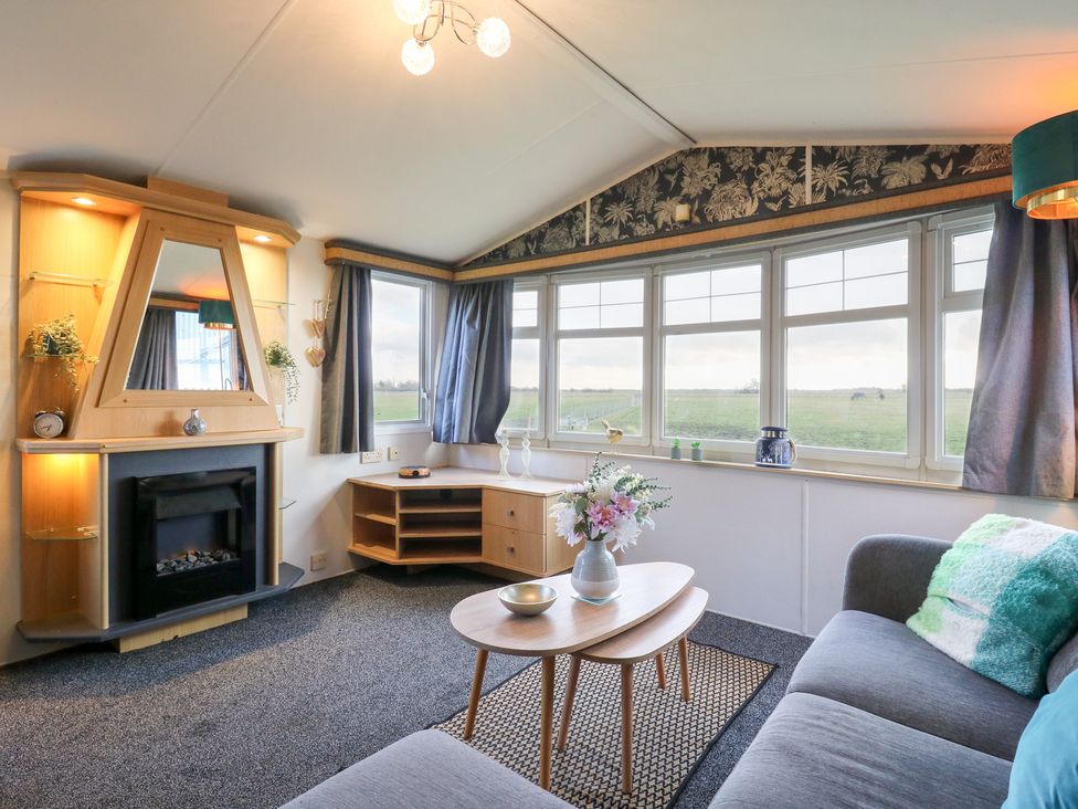 A living room with a sofa and coffee table at Granada at Avalon Eco Farm in Cambridge