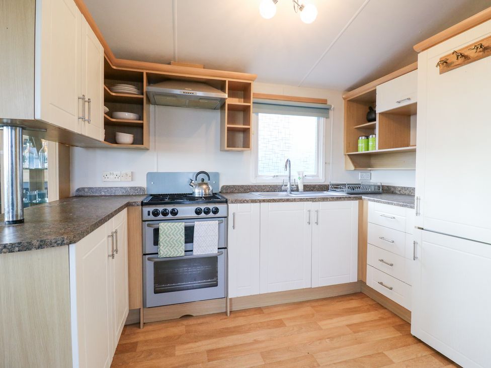 A kitchen with cabinets and a stove at Granada at Avalon Eco Farm, Cambridge
