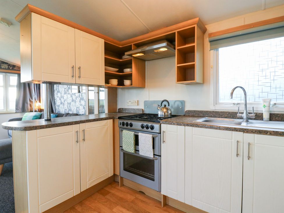 A kitchen with cabinets and stove at Granada at Avalon Eco Farm, Cambridge
