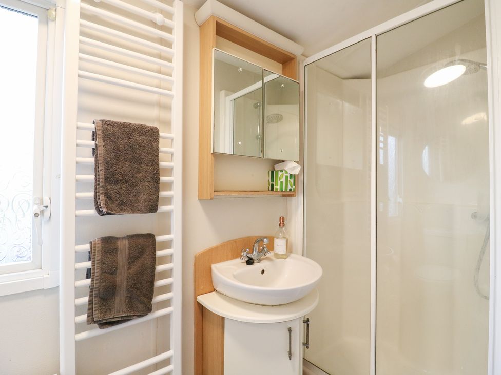 A bathroom with a sink and a shower at Granada at Avalon Eco Farm, Cambridge