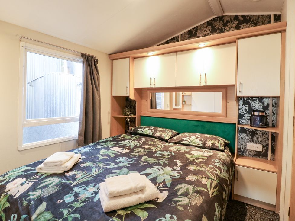 A bedroom with a bed and shelf at Granada at Avalon Eco Farm in Cambridge