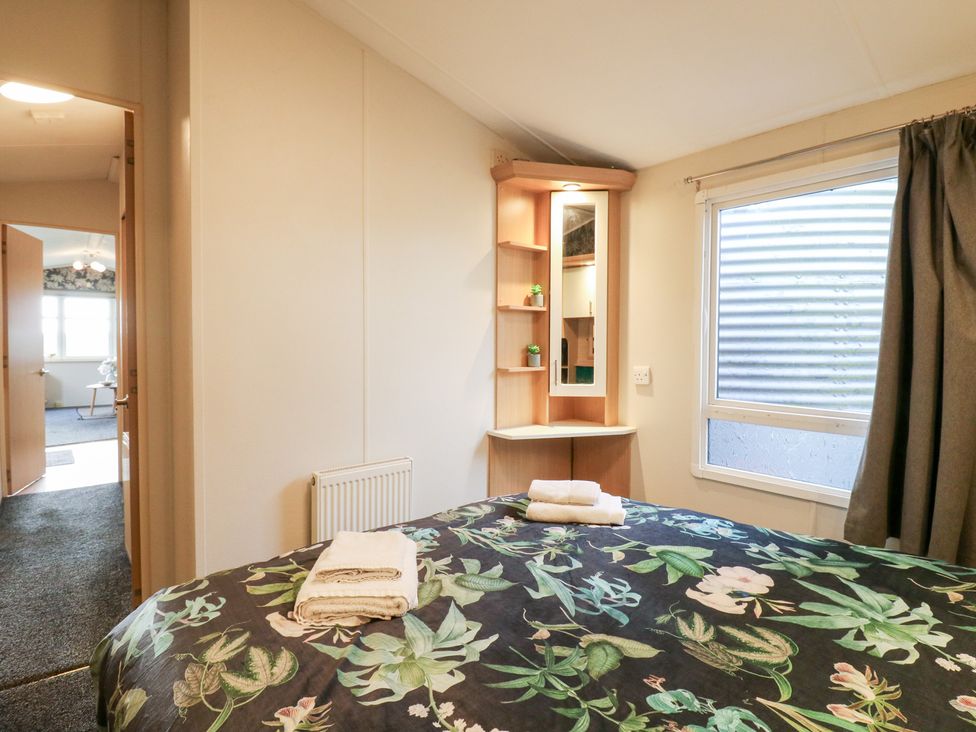 A bedroom with a bed and shelf at Granada at Avalon Eco Farm in Cambridge