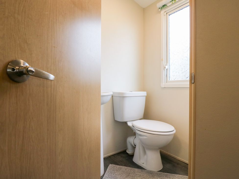 A bathroom with a toilet and window at Granada at Avalon Eco Farm, Cambridge