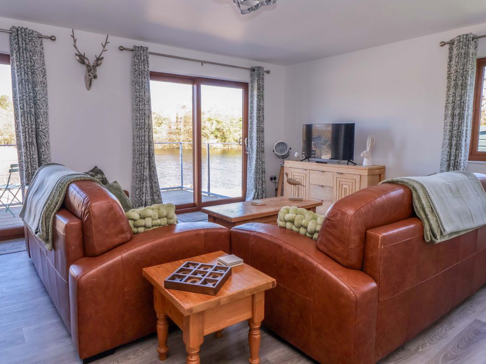 A living room with a sofa and coffee table at Star Carr Lakes
