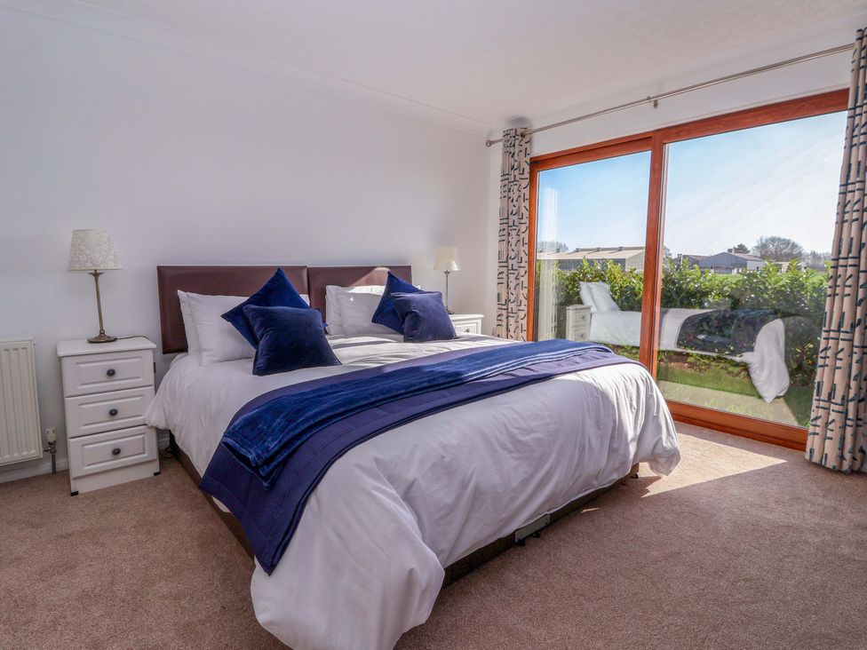 A bedroom with a bed and window at Star Carr Lakes 