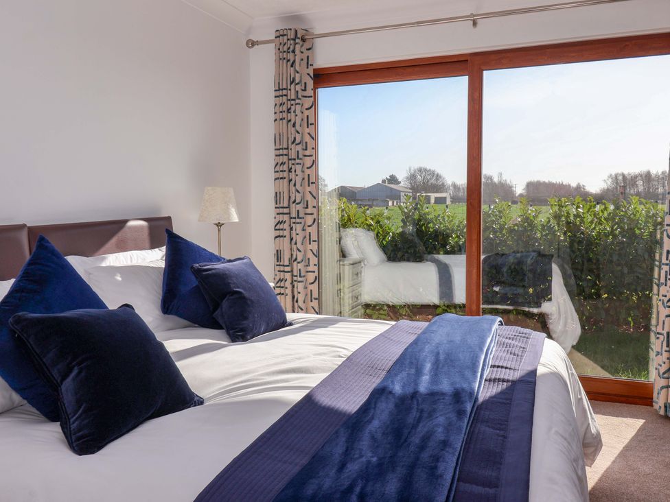 A bedroom with a bed and window at Star Carr Lakes
