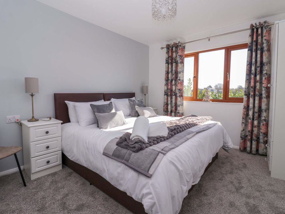A bedroom with a bed and window at Star Carr Lakes