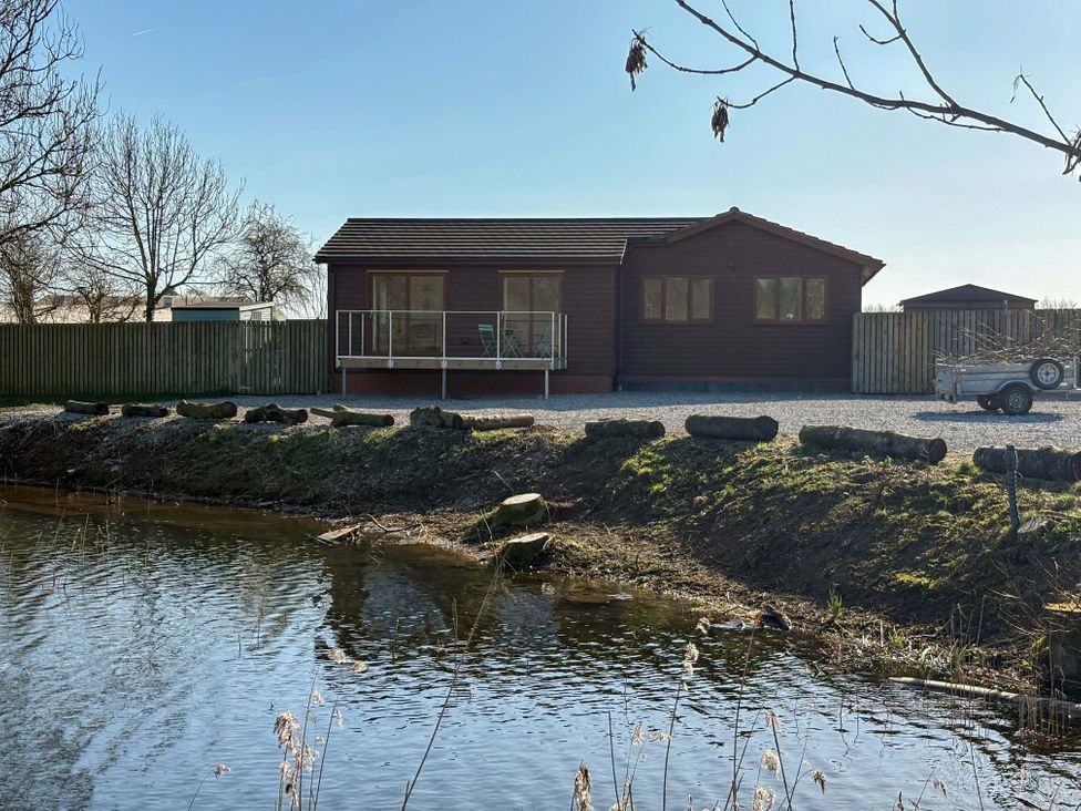 A house by a pond at Star Carr Lakes