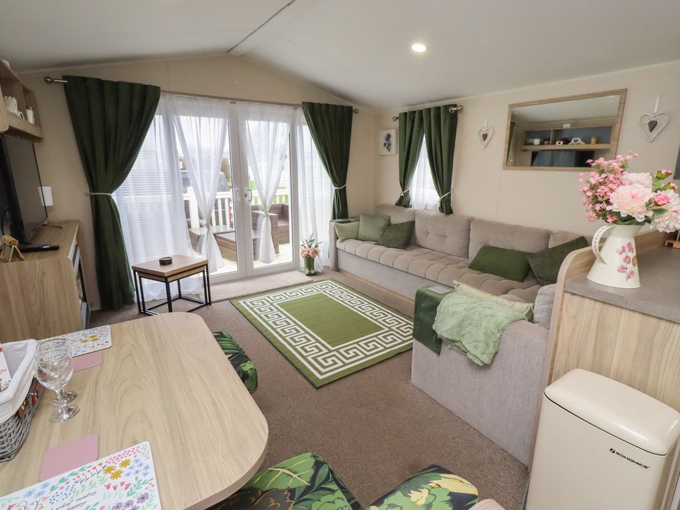 A living room with a sofa and table at Homeslea 33 Millennium Gardens, Morpeth