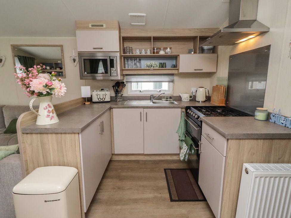 A kitchen with a sink and stove at Homeslea 33 Millennium Gardens in Morpeth