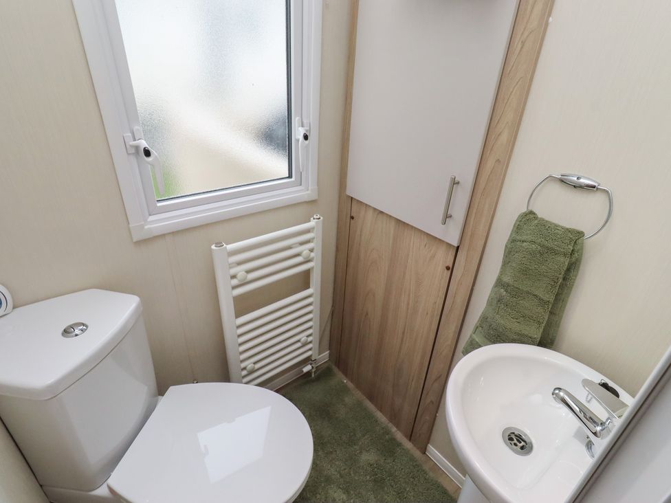 A bathroom with a sink and toilet at Homeslea 33 Millennium Gardens Morpeth