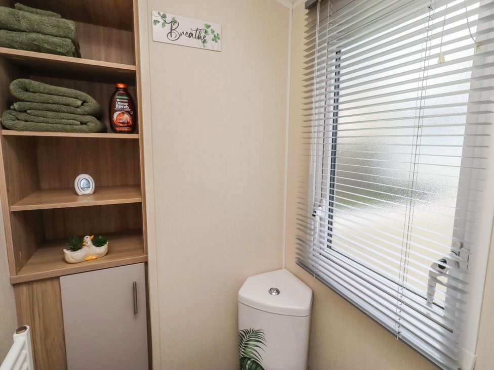 A bathroom with towels and a toilet at Homeslea 33 Millennium Gardens in Morpeth