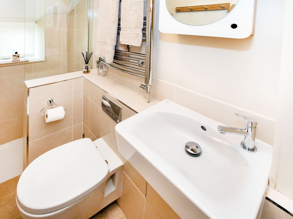 A bathroom with a toilet and sink at Gardeners Cottage in Chipping Norton