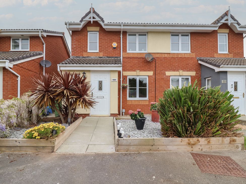 A house with plants and a pathway at 31 Llys Ogwen Prestatyn