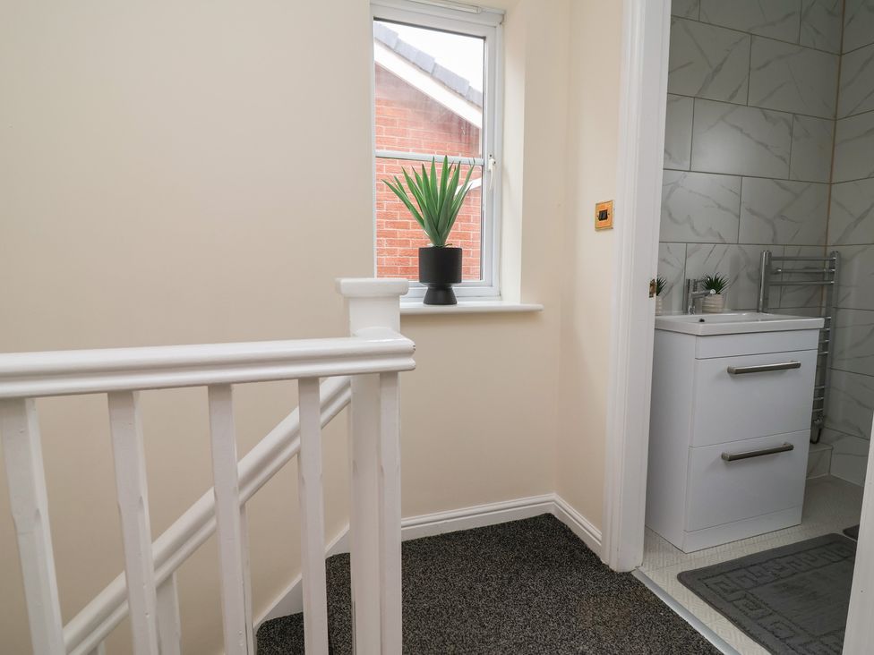 A bathroom with a sink and a plant at 31 Llys Ogwen in Prestatyn