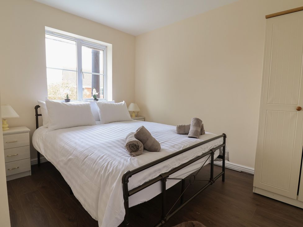 A bedroom with a bed and wardrobe at 31 Llys Ogwen in Prestatyn