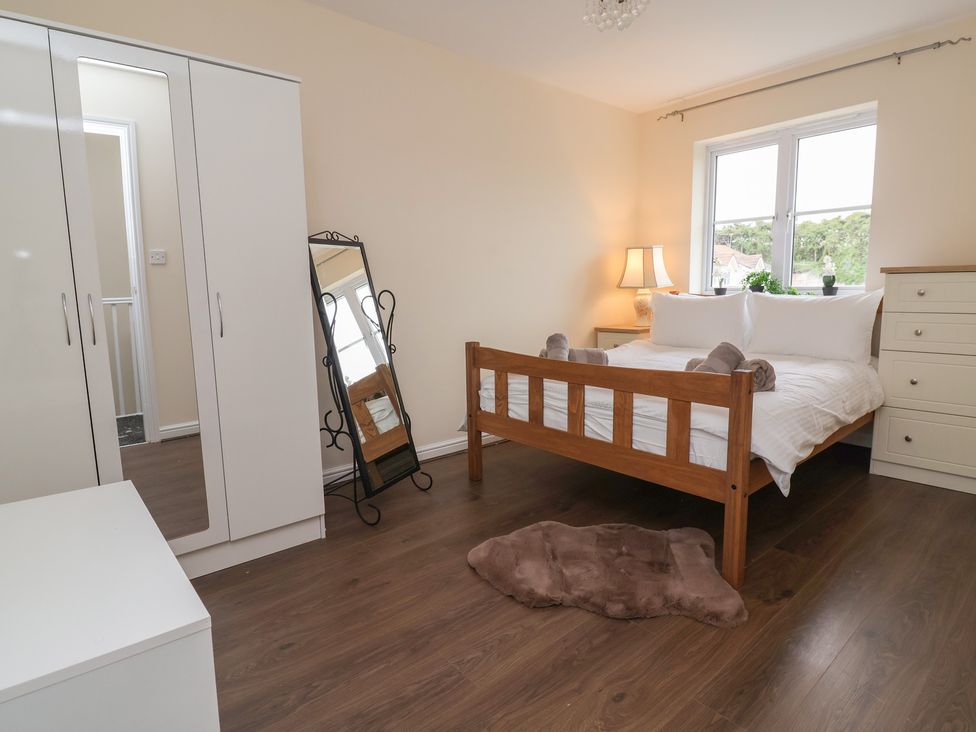 A bedroom with a bed and wardrobe at 31 Llys Ogwen Prestatyn