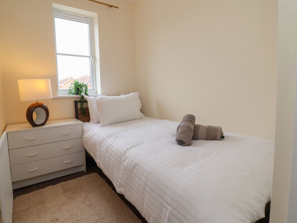 A bedroom with a single bed and drawer unit at 31 Llys Ogwen Prestatyn