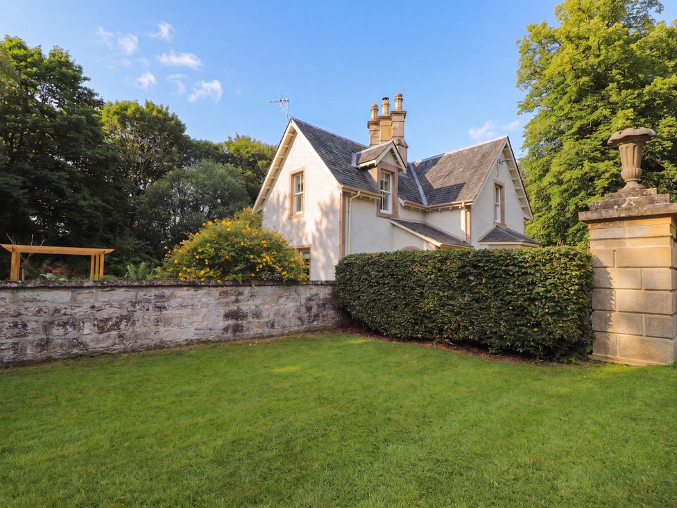 A house with a garden and fence at Station Lodge near Forres