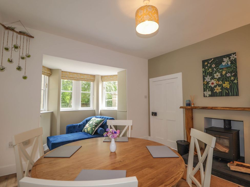 A dining room with a table and chairs at Station Lodge near Forres