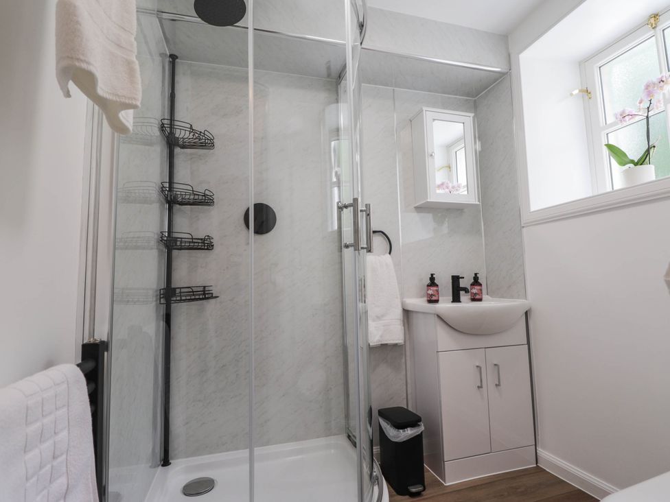 A bathroom with a shower and sink at Station Lodge near Forres