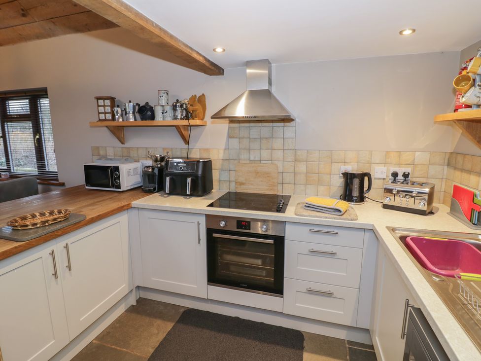 A kitchen with appliances and countertop at The Barn on The Lagoon Droitwich