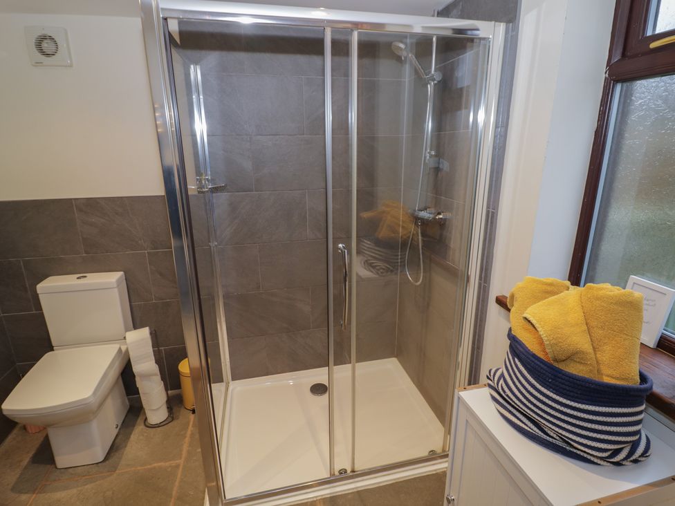 A bathroom with shower and toilet at The Barn on The Lagoon in Droitwich