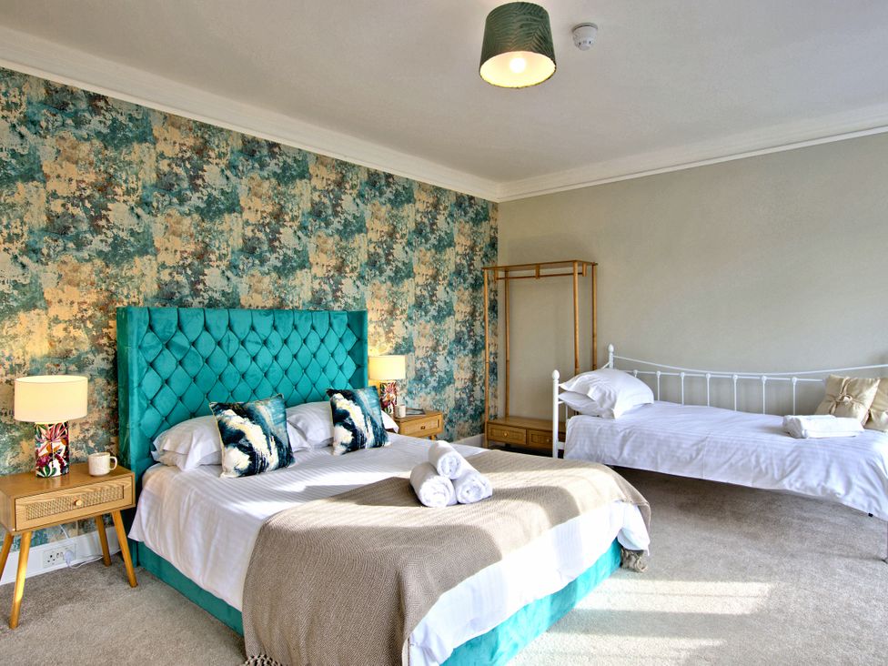 A bedroom with a bed and a single bed at Hanlith Hall near Malham