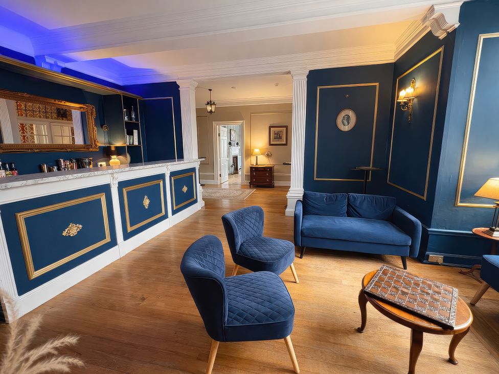 A lounge with seating and a bar at Hanlith Hall Hanlith near Malham
