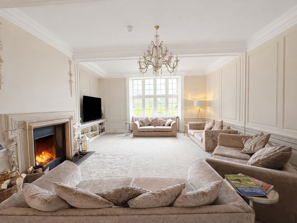 A living room with sofas and a fireplace at Hanlith Hall, Hanlith near Malham