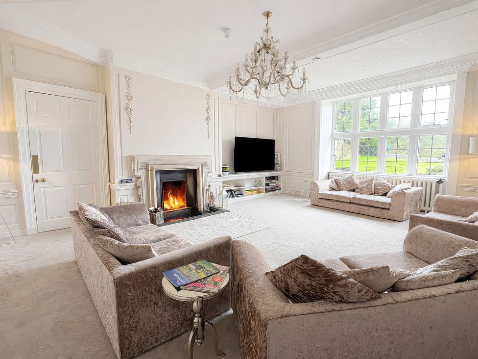 A living room with a fireplace and sofas at Hanlith Hall in Hanlith near Malham